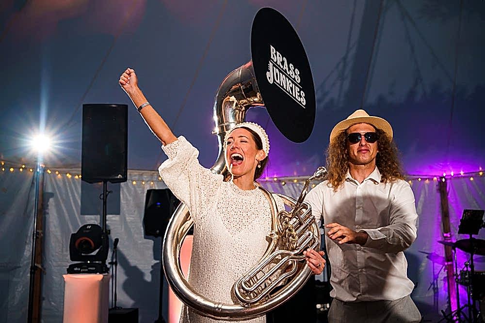 Musicians performing at an event with a tuba.