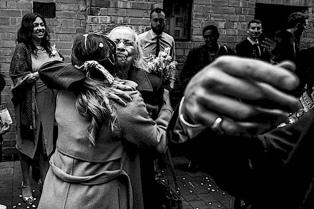 Emotional embrace at wedding celebration.