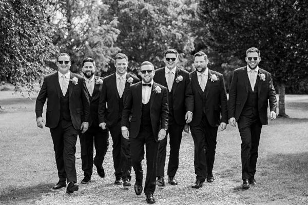 groom walking with best men and groomsman