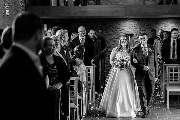 Bride walking down the aisle at wedding ceremony.