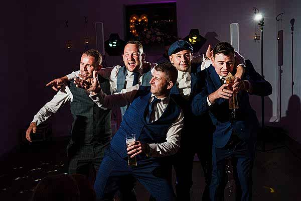 Group of men posing playfully at event.