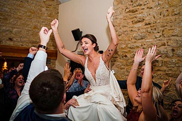 Bride celebrating with guests at wedding reception.