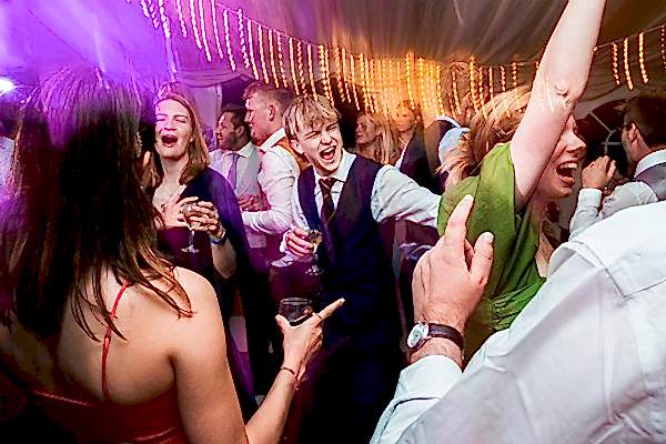 People enjoying a lively wedding reception dance.
