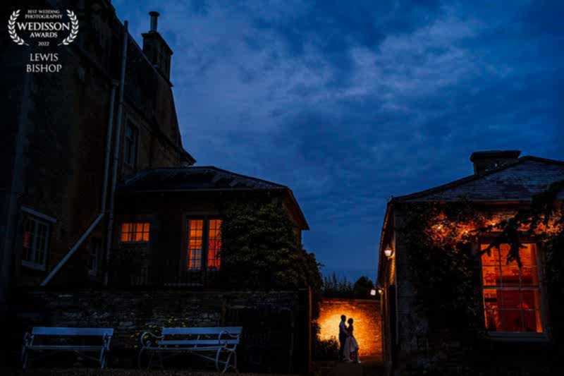 Couple silhouetted against evening light, romantic setting.