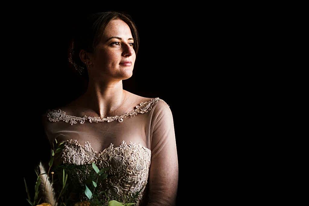 Woman in elegant dress with contemplative gaze.