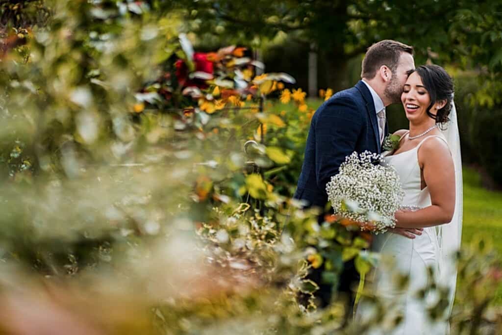 Couple embracing at garden wedding.