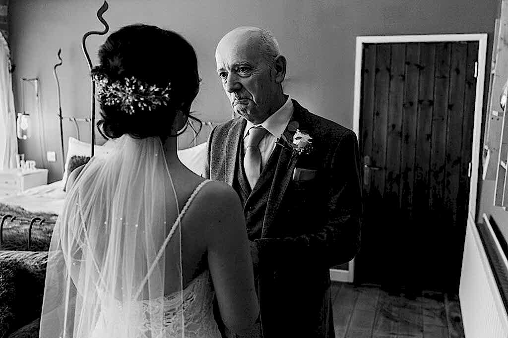 Father and bride share emotional moment before wedding.