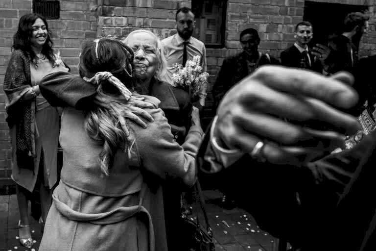 People hugging and celebrating at an outdoor event.