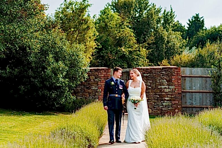 Bride and groom walking in garden