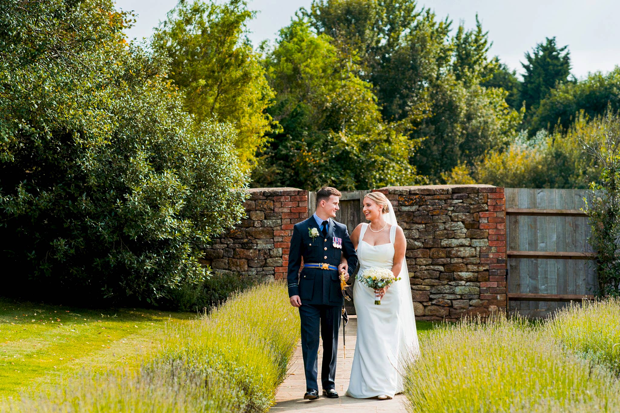 Bride and groom walking in garden