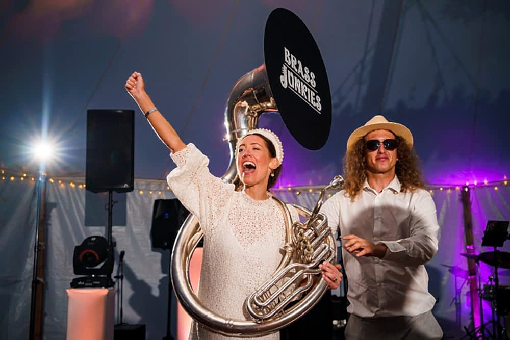 Musicians performing energetically at a lively event.