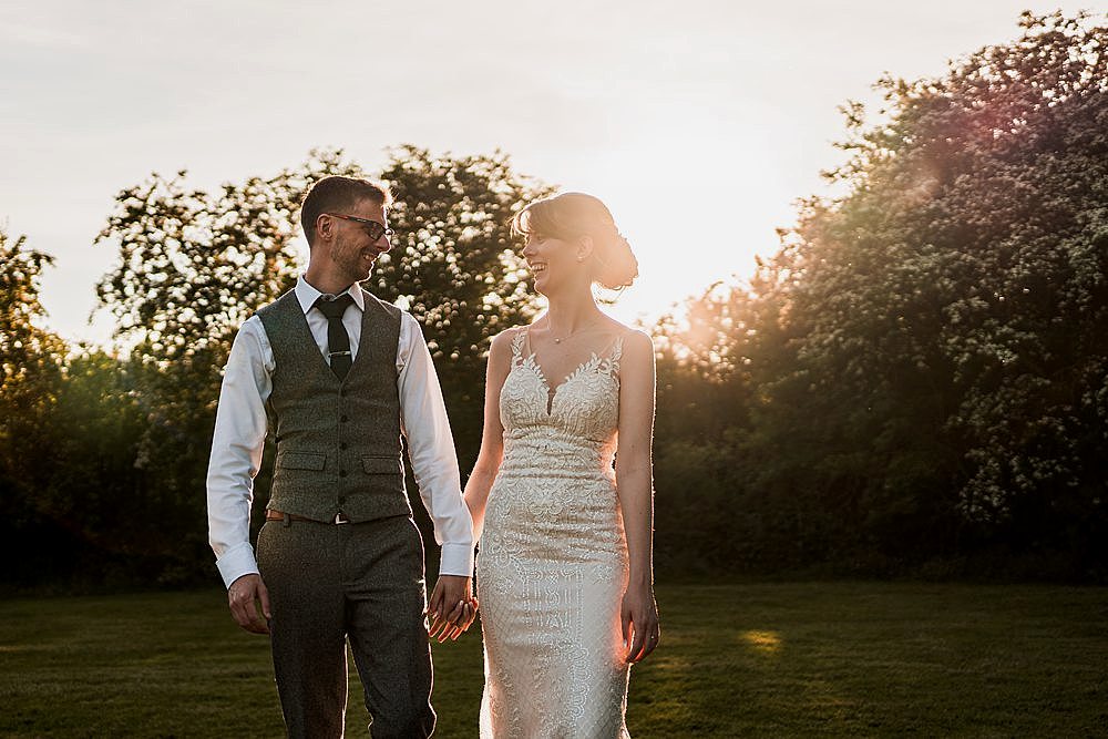 Couple holding hands in sunlit garden