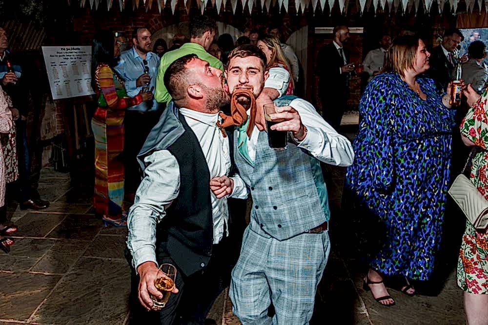 Two men dancing at lively party celebration.