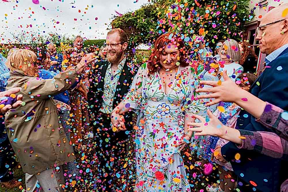 Colourful confetti shower at wedding celebration.