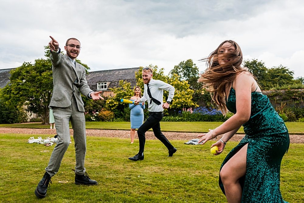 People playing garden games at outdoor event.