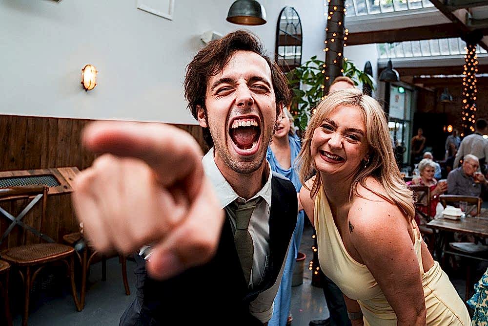 Cheerful people celebrating at indoor event.
