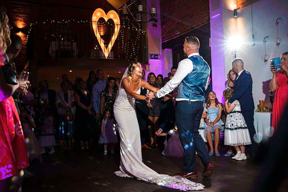 Bride and groom dancing at wedding reception.