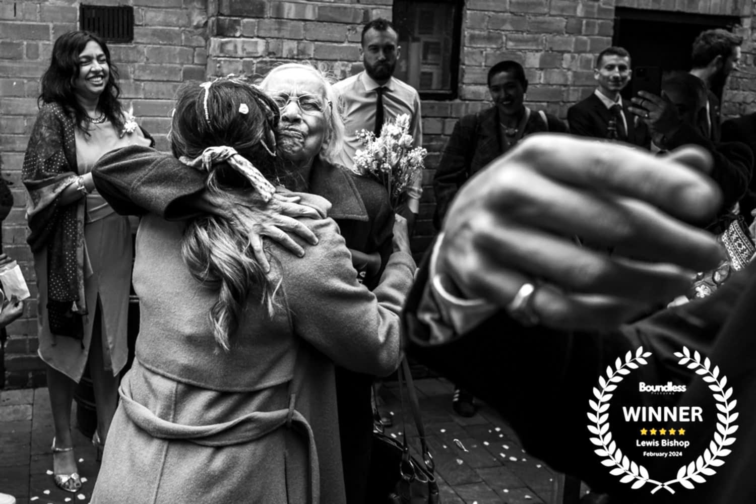Elderly woman hugging smiling friend at celebration event.