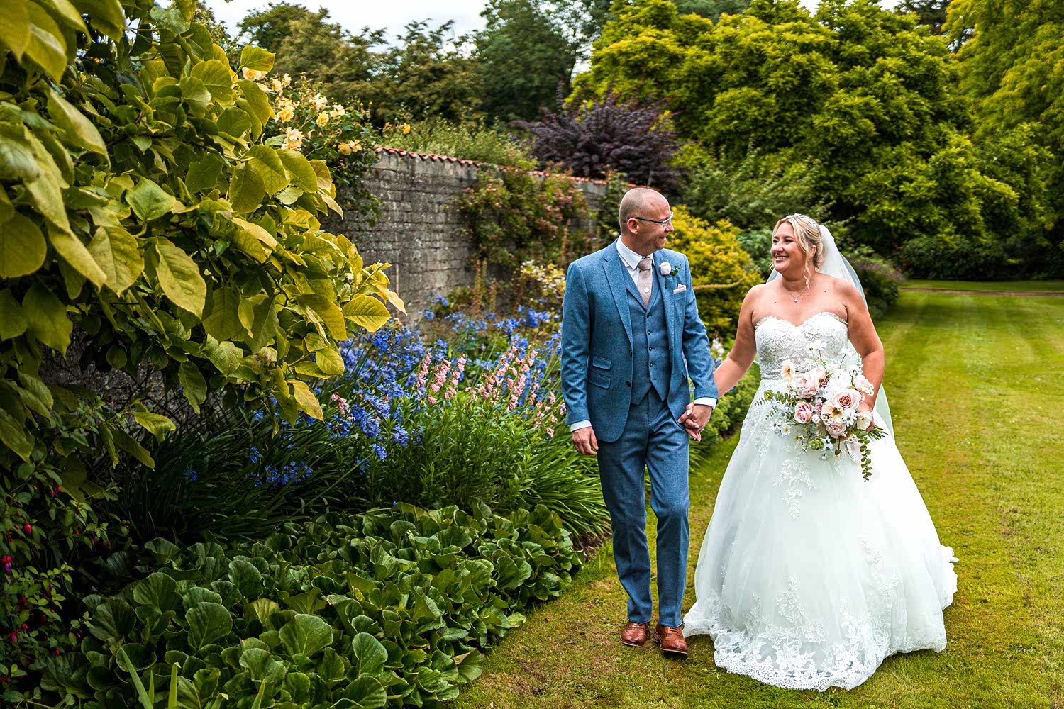 Bride and groom walking in garden