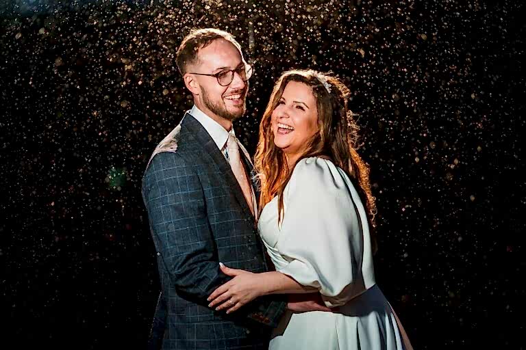 Smiling couple in evening rain