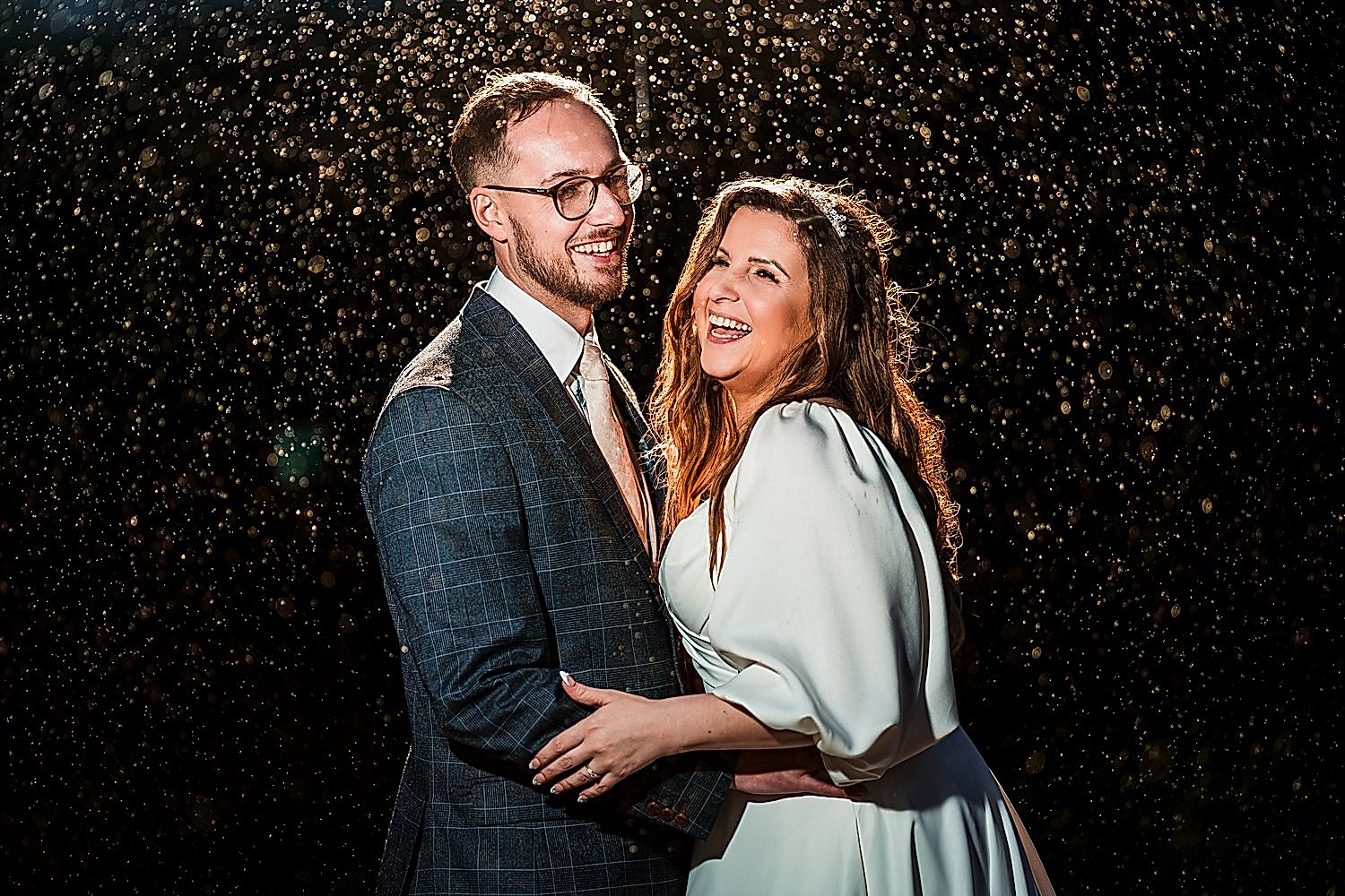 Smiling couple in evening rain