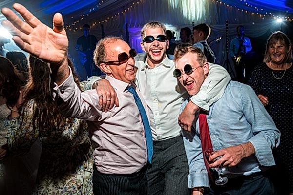 Guests celebrating at wedding reception with smiles