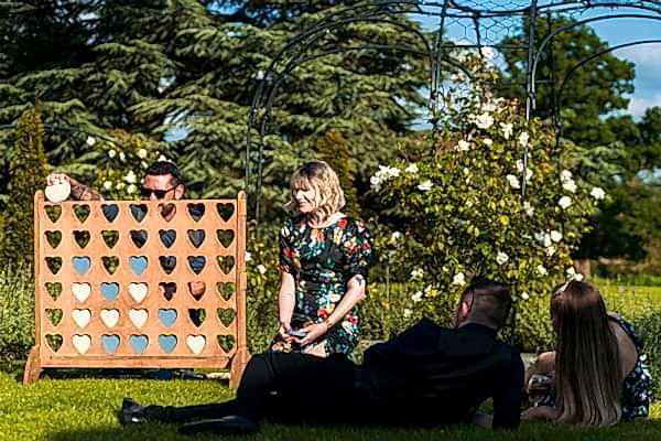 Garden gathering with Connect Four game.