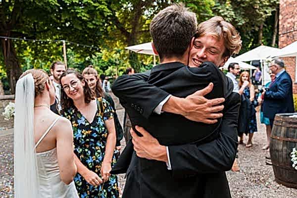 Guests congratulating couple at outdoor wedding