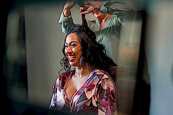 Woman smiling while having hair styled