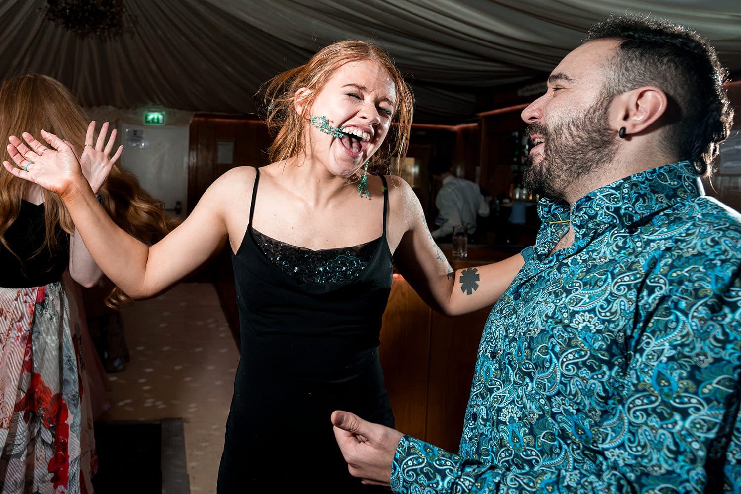 People laughing and dancing at a party.