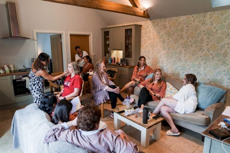 Group of women getting ready in comfortable room.