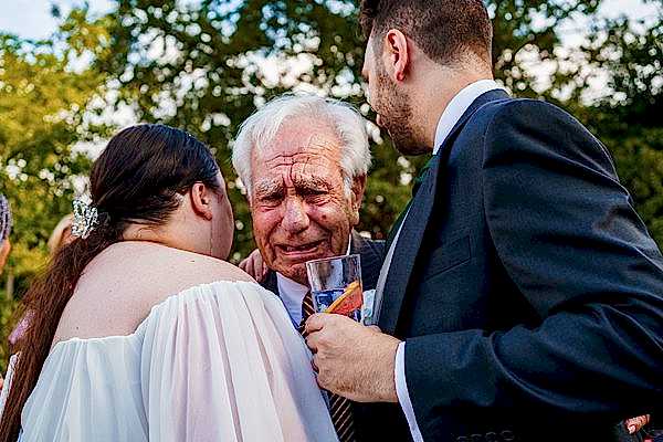 Emotional moment between people at outdoor gathering.