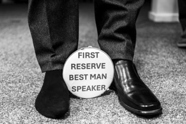 Best man sign with dressed shoes and socks