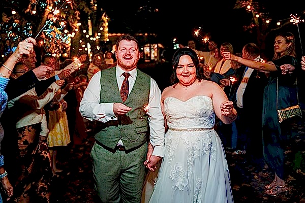 Bride and groom with sparklers on wedding night.