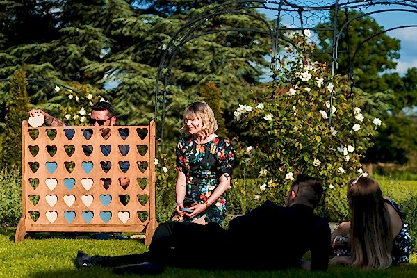 People playing garden game on sunny day