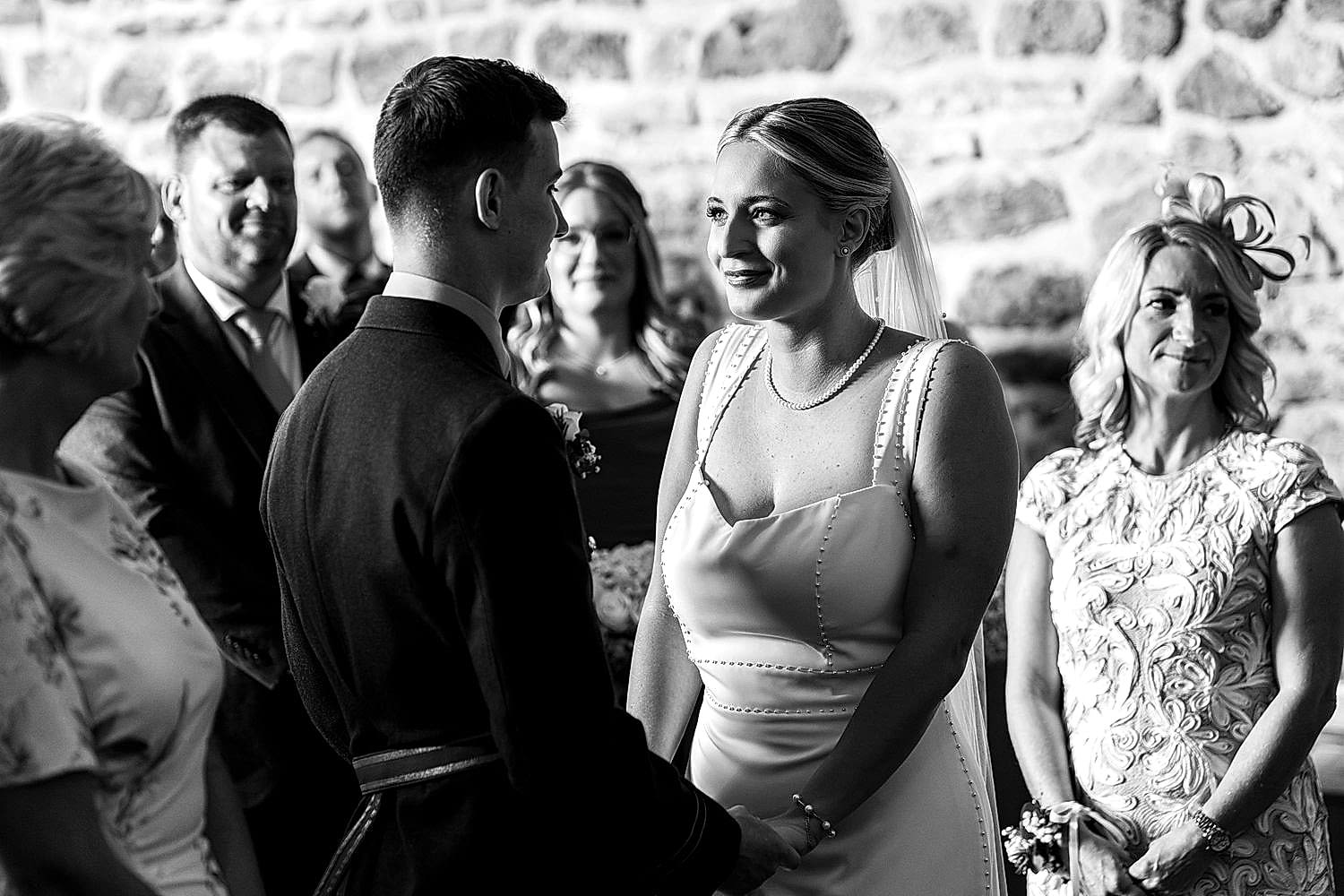 Bride and groom smiling during wedding ceremony