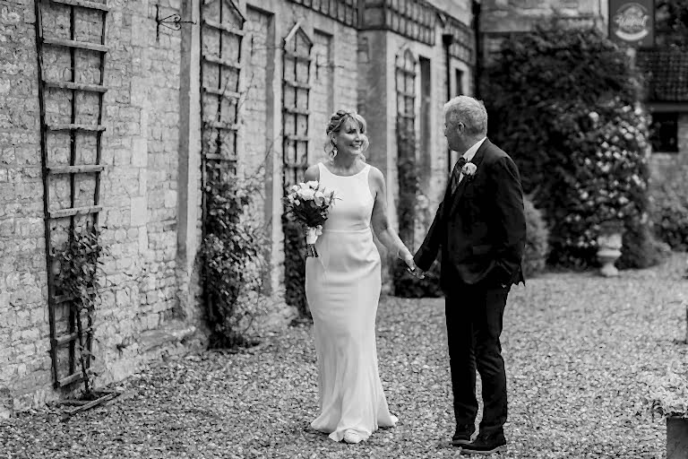 Couple holding hands on their wedding day.