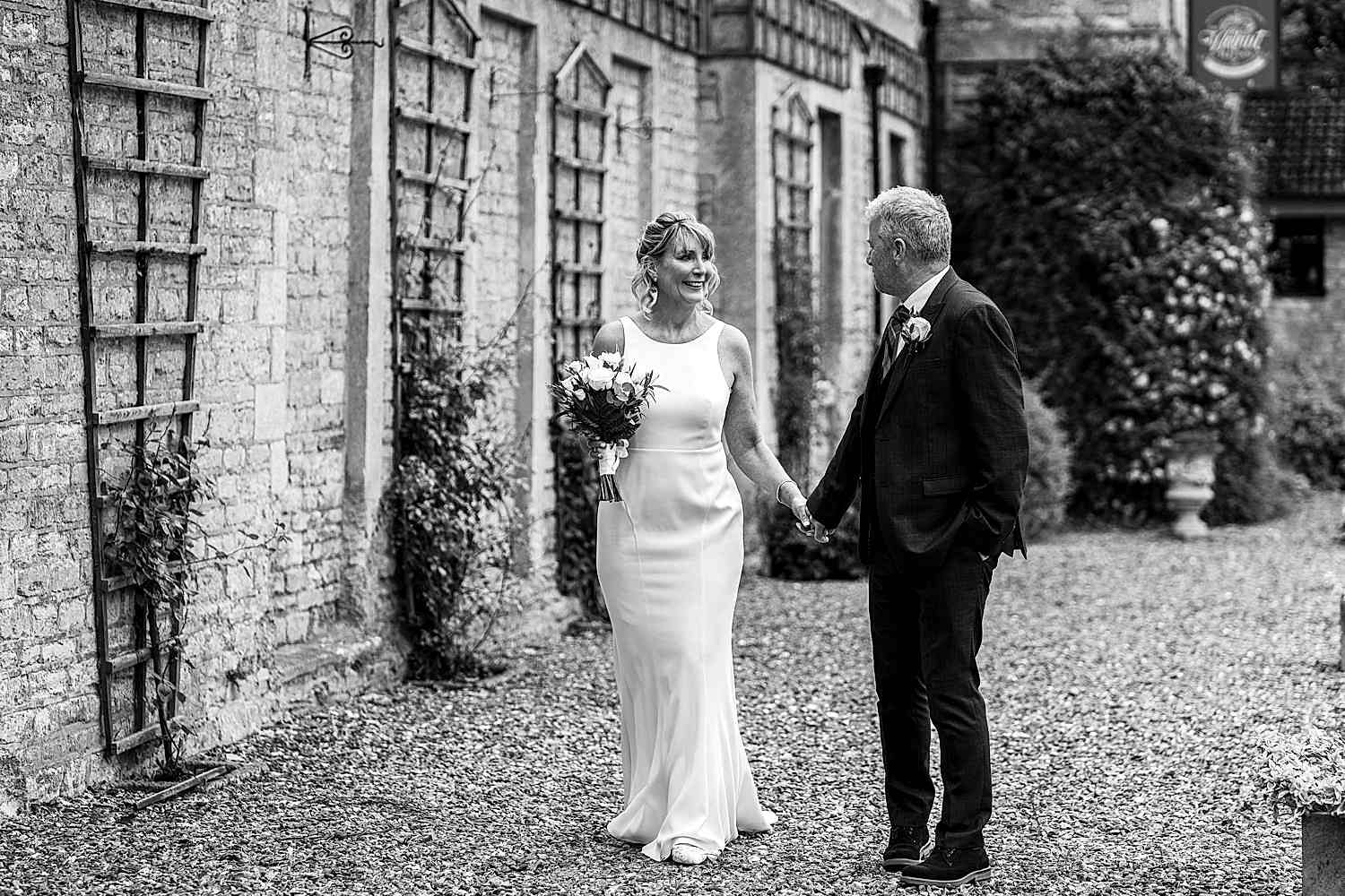 Couple holding hands on their wedding day.