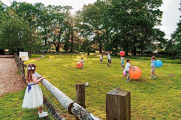 Children playing with balls in sunny field