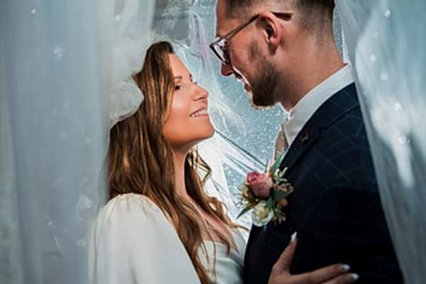 Happy couple embracing on wedding day