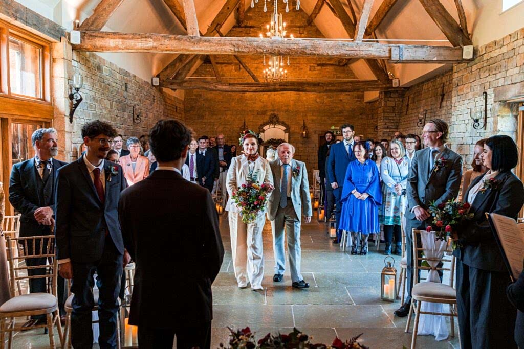 Wedding ceremony in rustic stone barn venue.
