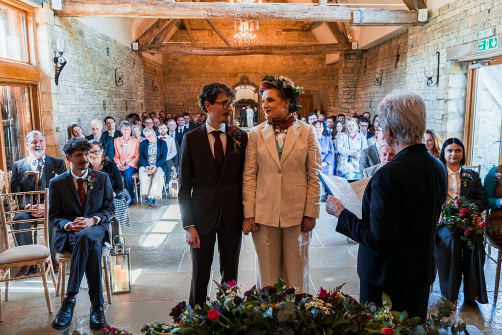 Couple getting married in rustic ceremony with guests.