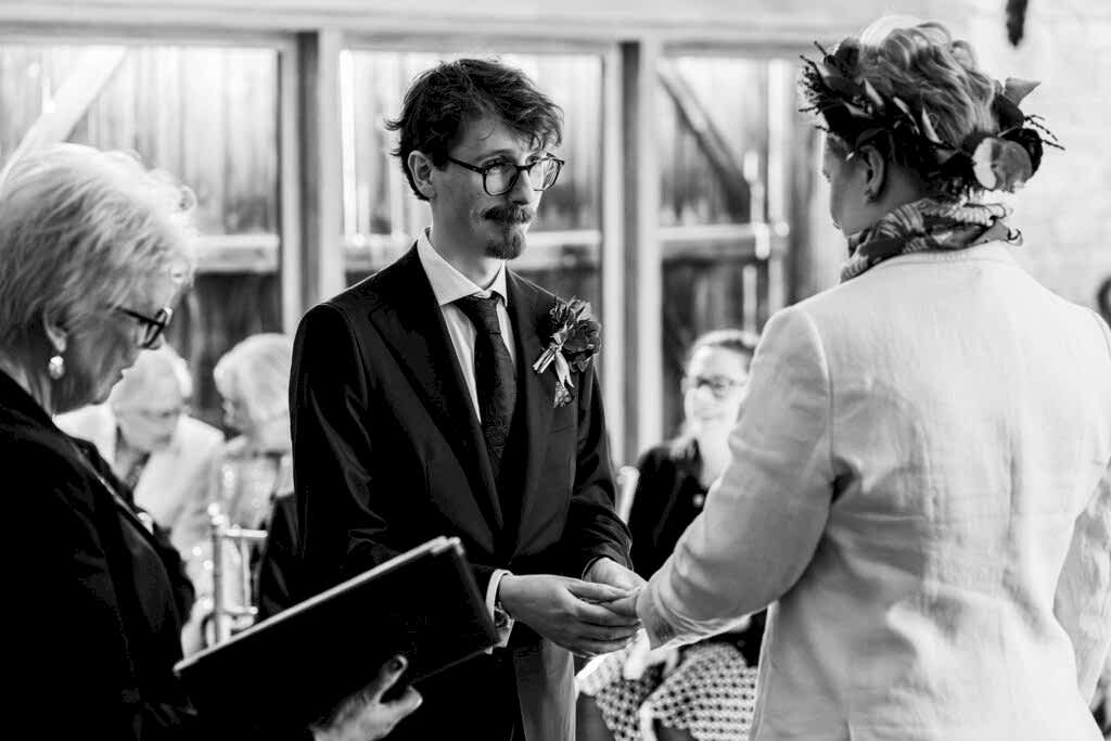 Wedding ceremony with couple exchanging rings.