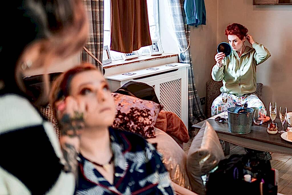 People getting ready with makeup and mirror.