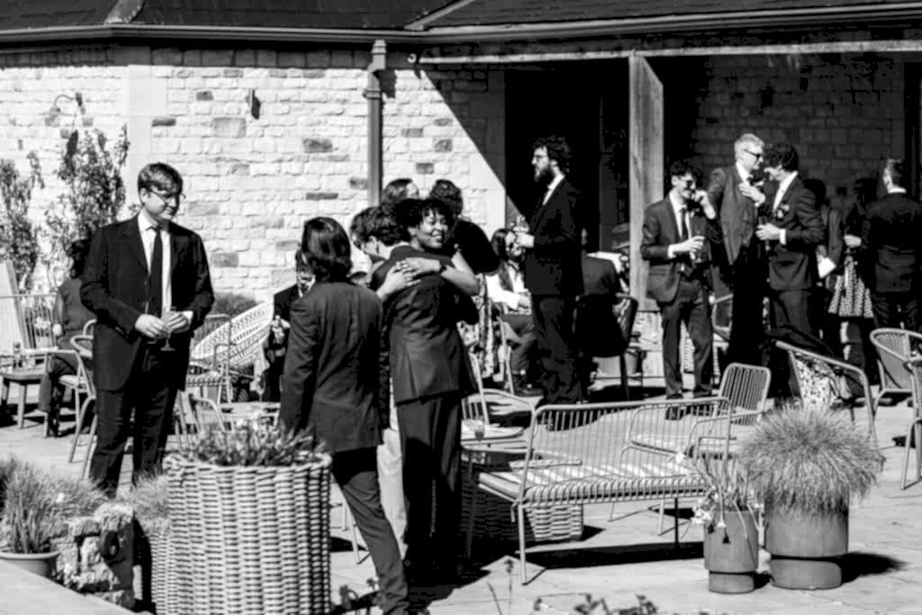 People socialising outdoors at formal event.