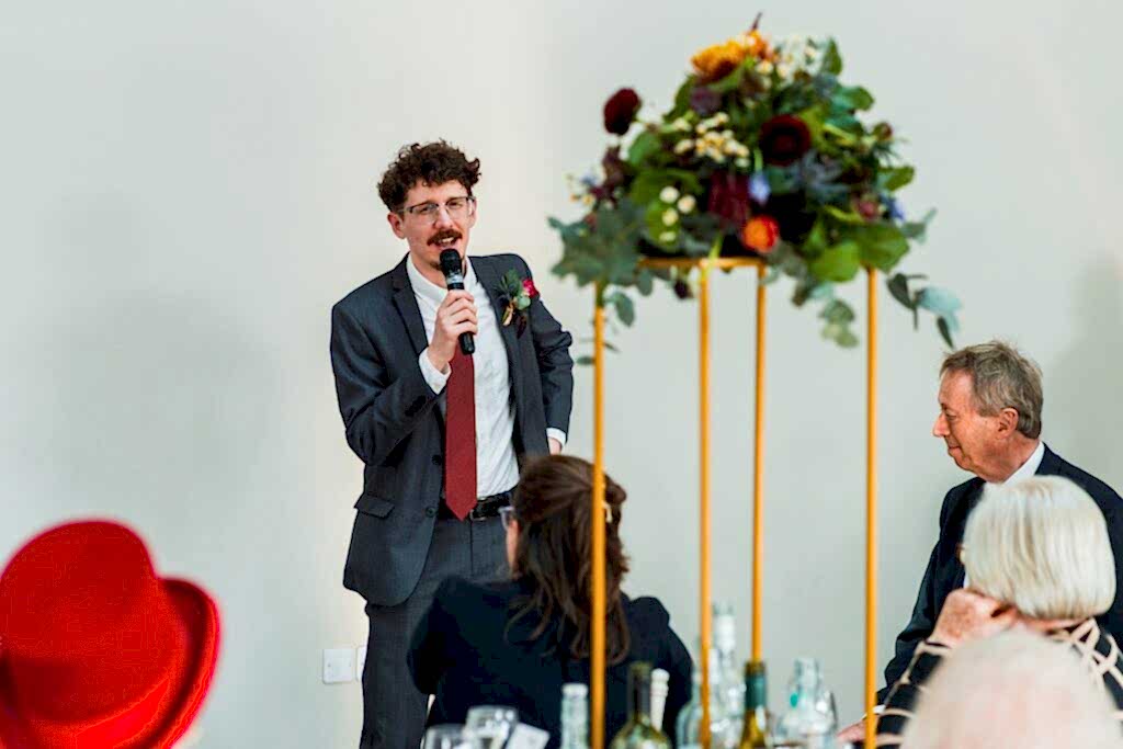 Man giving a speech at a formal event.