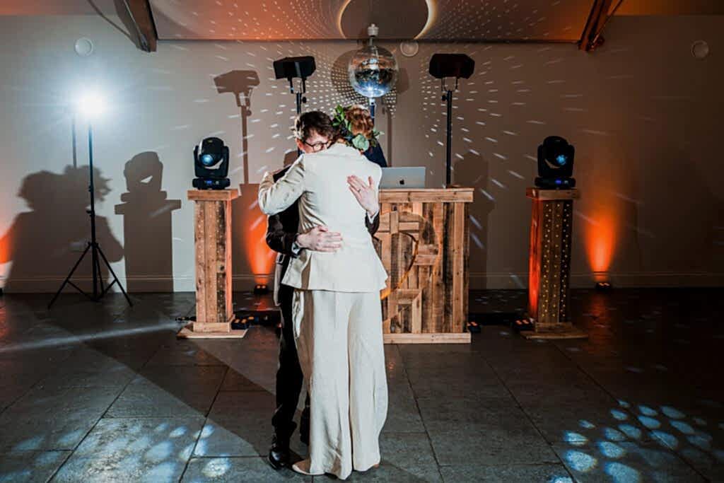 Two people hugging on the dance floor.