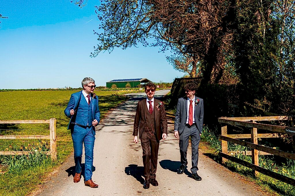 Three men in suits walking outdoors
