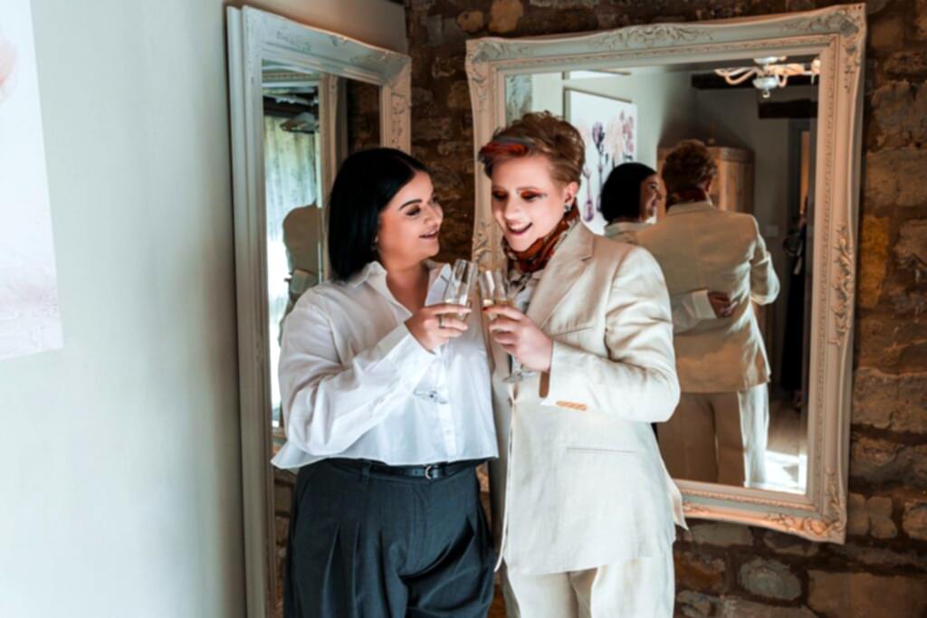 Couple toasting with champagne in mirror reflection.
