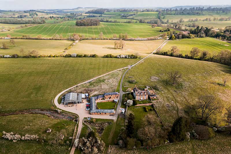 Aerial view of English countryside farm and fields.
